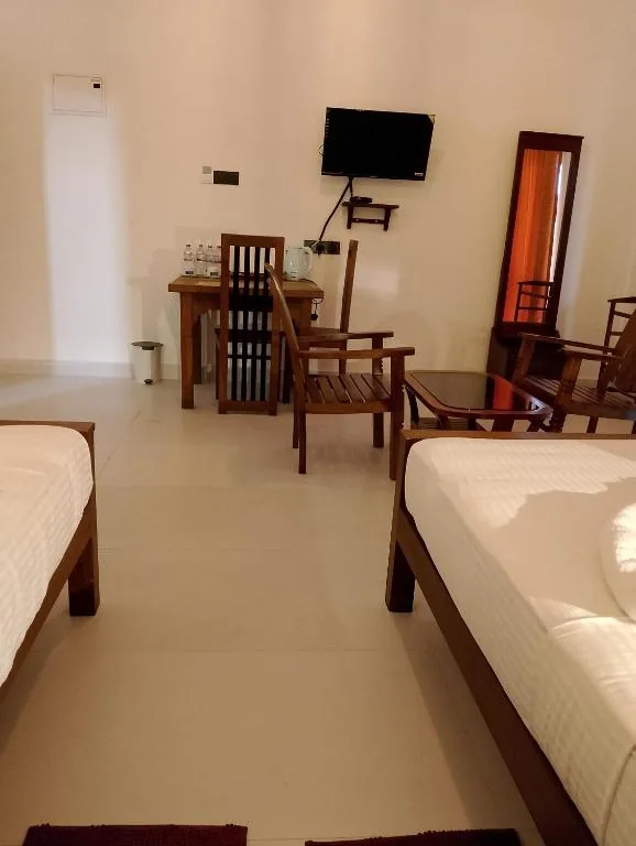 Room view with TV, dining table and seating